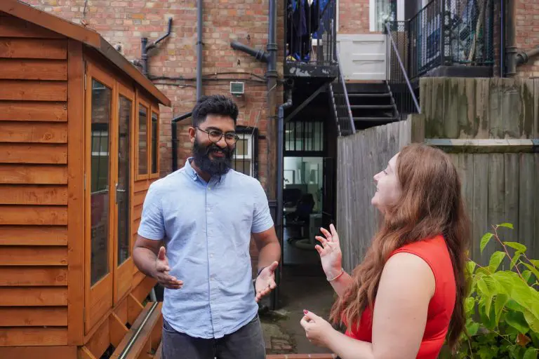 Two team members having a conversation outside the Resknow office