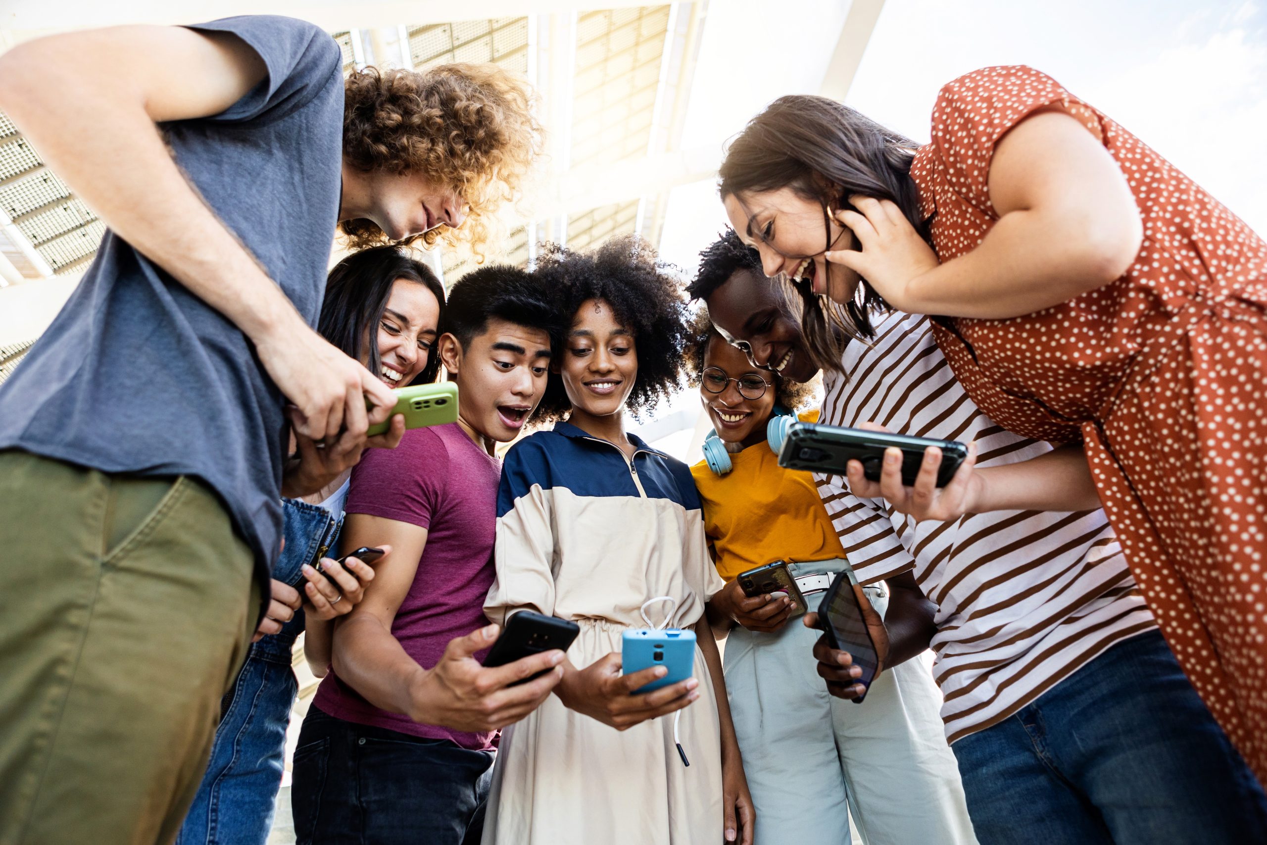 group-of-multiracial-people-using-cellphone-outdoor