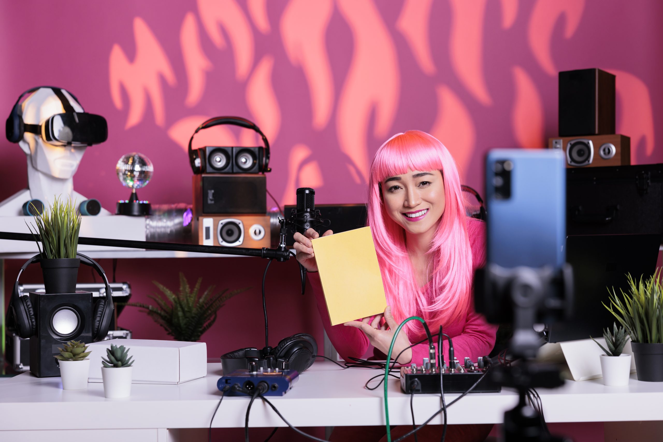 smiling-asian-content-creator-holding-notebook
